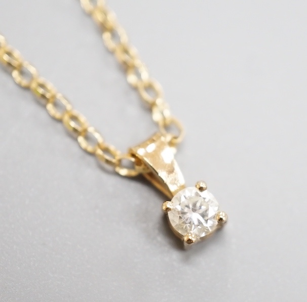 A modern 9ct gold and diamond set pendant, on a 9ct gold chain, chain, 38cm, gross weight 2.2 grams.